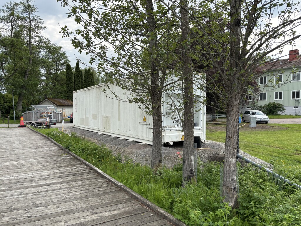 Mobile technical installation unit near the riverfront site.