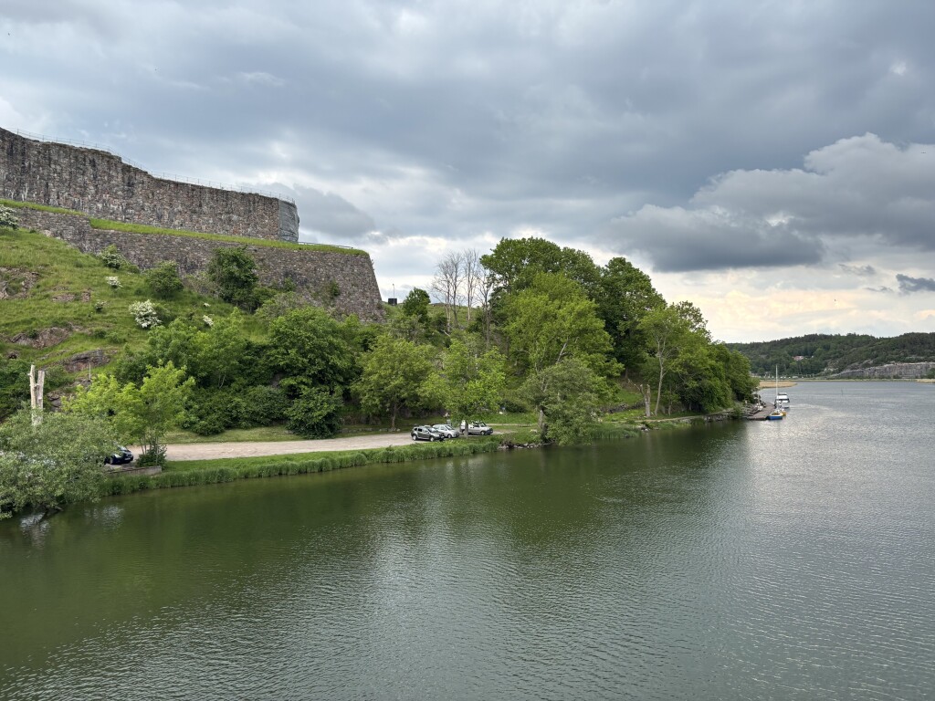 River landscape and fortress walls under changing weather conditions.