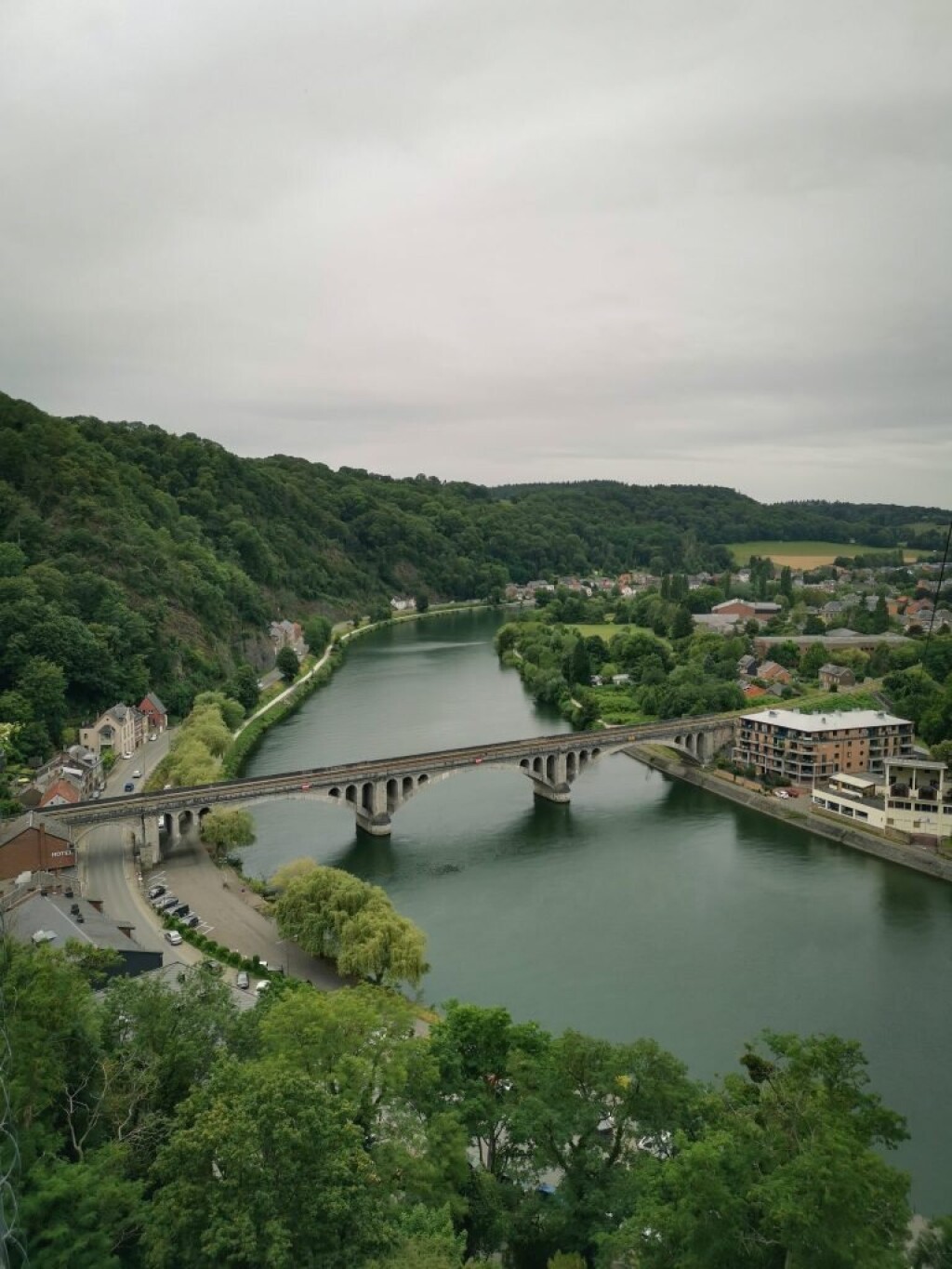 Aerial view of the Meuse River and bridge crossing through the valley.