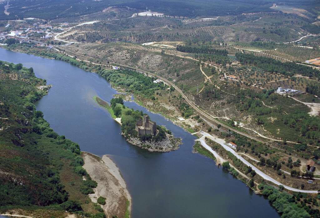 Aerial landscape view of the river basin and historic riverside structure.
