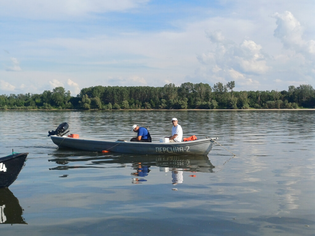 Researchers conducting fish monitoring from a small boat on the Danube.